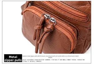 Detail view of high-density metal zipper and PU knot pendant on a brown leather bag
