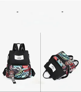 Front and flat views of a black floral backpack with vibrant tropical leaf print pattern