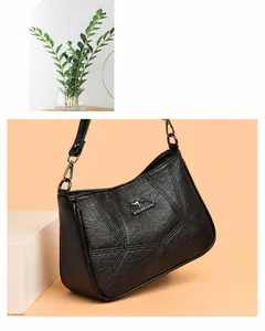 Detail of black soft leather shoulder bag featuring geometric stitching and silver kangaroo logo