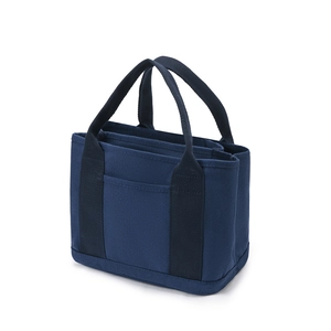 Navy blue canvas tote bag with outer pocket and double handles in a 45-degree studio shot