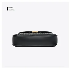 Detail view of the flat bottom and precise stitching on black quilted leather handbag