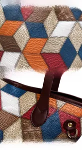 Close-up of patchwork leather tote showing texture, stitching and metal D-ring detail