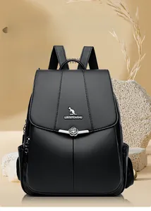 Detail of lychee textured black leather backpack with metallic flower clasp and logo