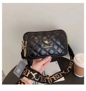 Close-up of black quilted leather bag featuring golden kangaroo logo and printed strap
