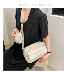 Detail of beige woven crossbody bag with small round pouch and wide shoulder strap