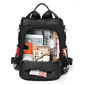 Women's anti-theft printed backpack with large capacity shown with travel essentials