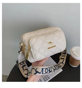 Close-up of white quilted crossbody bag with dual zippers and gold kangaroo logo