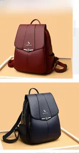 Detail of vintage PU leather backpacks with lychee texture and floral metal buckle
