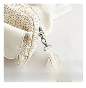 Detail of silver metal hook and premium woven texture on beige crossbody bag
