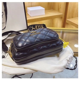 Detail of black quilted leather crossbody bag with golden kangaroo logo and wide strap