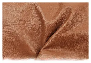 Macro shot of high-quality brown leather texture with natural grain for crossbody bag
