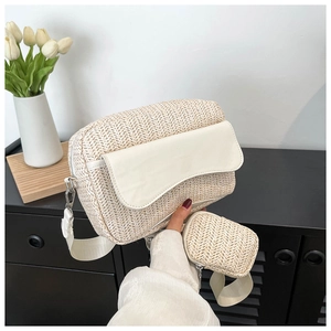 Detail of woven straw shoulder bag with white leather flap and matching mini coin purse