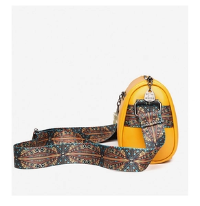 Detail of yellow cylinder bag featuring a colorful Bohemian style woven shoulder strap