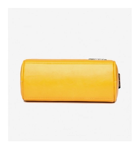 Detail of yellow cylinder bag showing fine white stitching and rainbow webbing texture