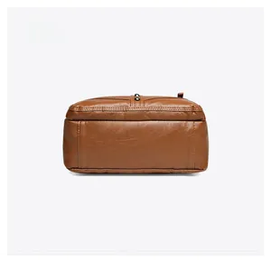 Detailed bottom view of brown soft leather crossbody bag with stitching and pebble texture
