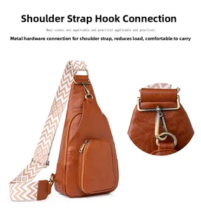 Detail of vintage brown leather sling bag with geometric woven strap and bronze hardware