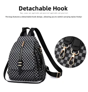 Détail du crochet en métal doré amovible sur le sac à dos à motif géométrique noir et blanc