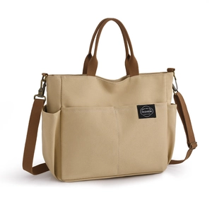 Grand sac cabas en toile kaki avec poignées marron et conception à poches multiples