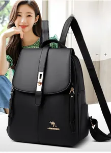Detail of black pebbled leather backpack featuring a gold metal buckle and side zipper pocket