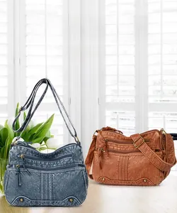 Nahaufnahme von Vintage-Umhängetaschen aus weichem Leder in Blau und Braun mit Reißverschlüssen