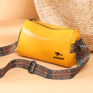 Yellow cylinder Boston bag with patterned wide strap and metallic kangaroo logo