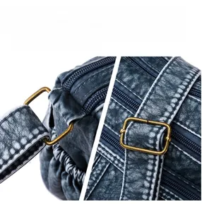 Nahaufnahme der Bronzeschnalle und Reißverschlussdetails an der Vintage-Lederhandtasche