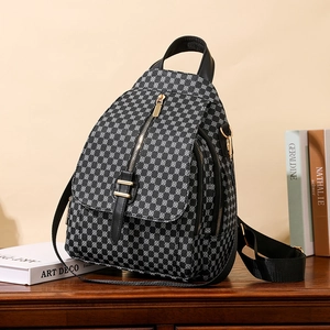 Sac à dos femme motif géométrique Art Déco avec détails dorés sur table en bois