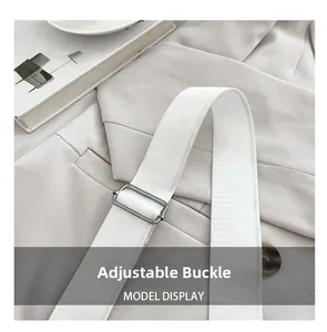 Detail of adjustable strap with matte silver metal buckle on a white soft leather bag