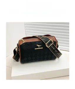 Macro detail of quilted crossbody bag with golden kangaroo logo and woven shoulder strap