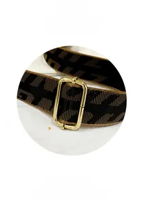 Detail view of woven jacquard shoulder strap with vintage gold-tone metal hardware