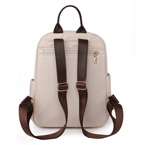 Vue arrière détaillée d'un sac à dos beige pour ordinateur avec sangles brunes et poche antivol