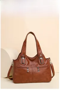 Detailed view of brown vintage tote bag with PU texture, silver zippers and adjustable straps