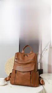 Close-up of brown PU leather backpack with vintage texture and functional pockets