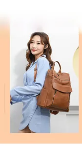 Close-up of brown faux leather backpack with magnetic flap pocket and multi-zipper detail