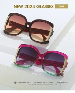 Detail view of square gradient oversized sunglasses with gold metal accents on frame