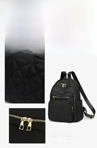 Detail of black quilted nylon backpack featuring geometric stitching and gold zippers