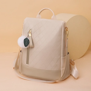 Chic quilted beige PU leather backpack with plush ball charm and top handle styling