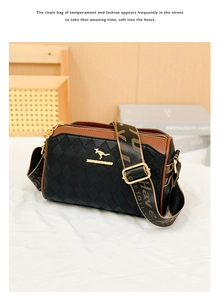 Detail of quilted leather pillow bag with gold kangaroo logo and woven shoulder strap