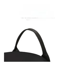Detail of the comfortable black fabric handle with reinforced stitching on the backpack