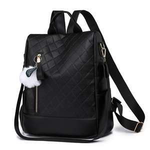 Fashionable black PU leather quilted backpack with a white plush pompom keychain accessory