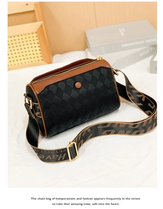 Detail of quilted leather pillow bag with wide jacquard strap and gold hardware