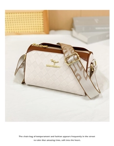 Detail of white quilted leather crossbody bag with brown trim and woven shoulder strap