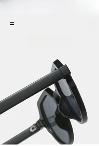 Detail view of durable metal hinges and polished black frame on vintage sunglasses