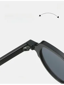 Detail shot of durable metal hinge on retro small frame black sunglasses for women