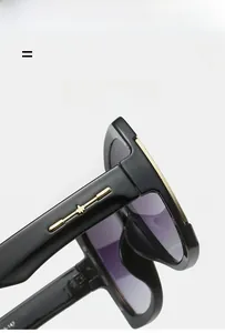 Detail of black sunglasses featuring golden star metal decor and purple gradient lenses