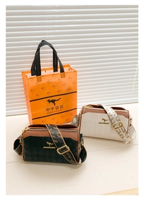 Detail of black and cream quilted bags with jacquard straps and brand packaging