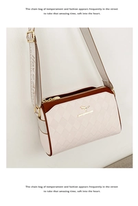 Detailed close-up of quilted pattern and gold kangaroo logo on two-tone crossbody bag