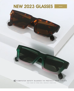 Detail of tortoise shell and green-pink gradient rectangular sunglasses on white display