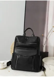 Detail of black pebbled leather backpack with multi-layer zippers and side pockets