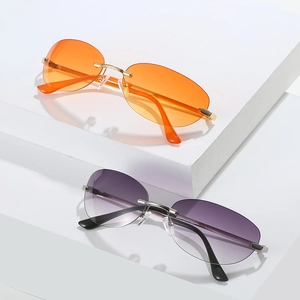 Fashionable rimless cat eye sunglasses with orange and purple gradient lenses on display